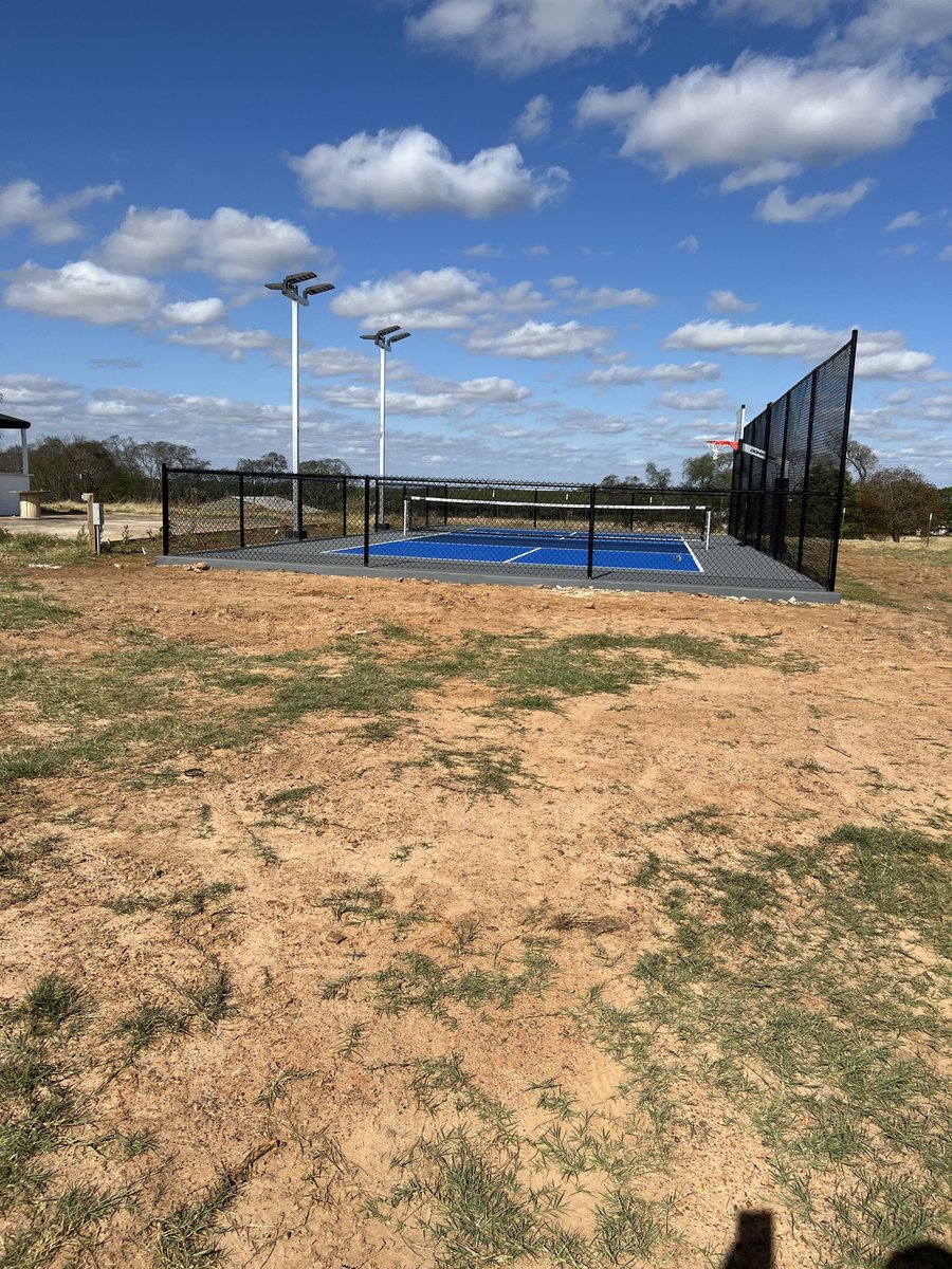 Dark stained cedar fence in Pilot Point TX by Landeros Fence & Construction